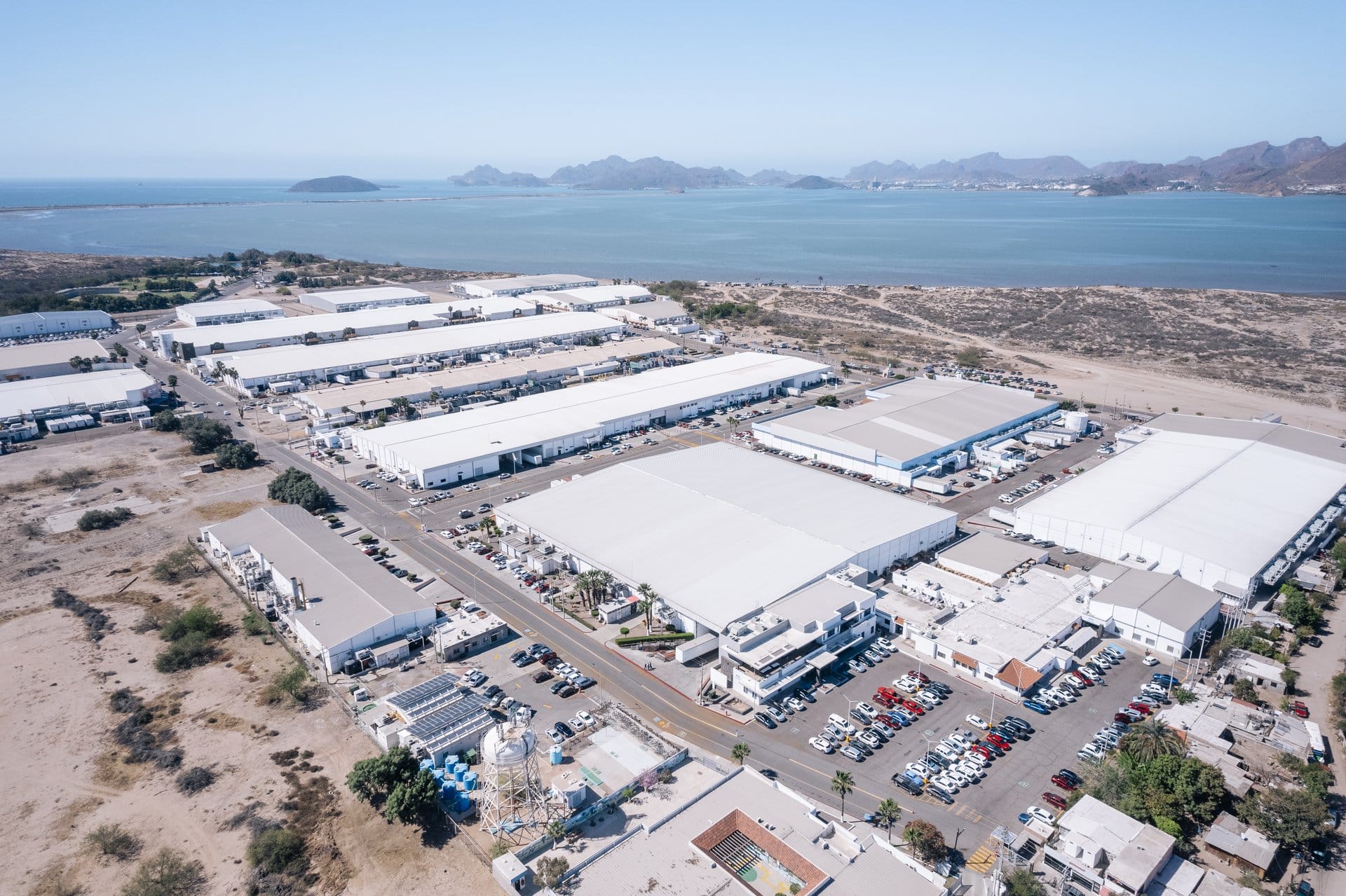 Aerial view of an industrial park with manufacturing facilities along the coast in Guaymas, Sonora, Mexico | Tetakawi