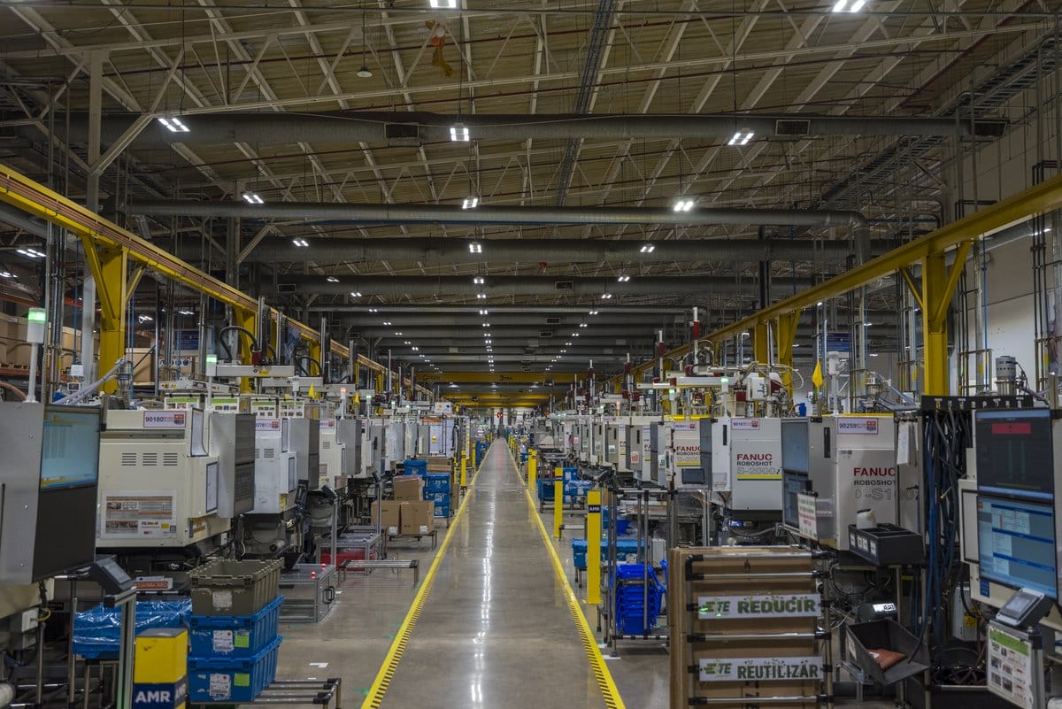 Rows of injection molding machines run a production line at a Tetakawi Manufacturing Campus in Mexico | Tetakawi