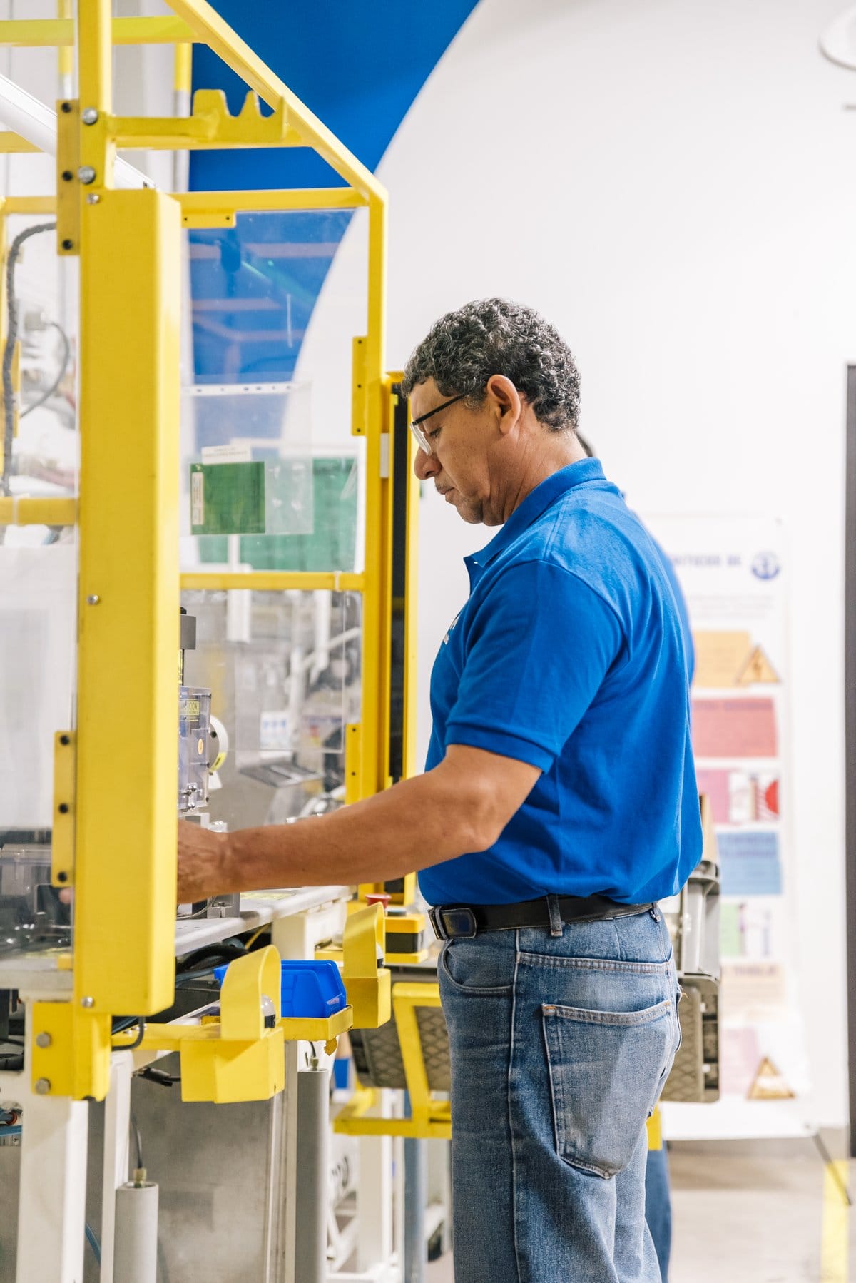 Tetakawi employee operating precision manufacturing equipment in Mexico, reflecting skilled labor value | Tetakawi