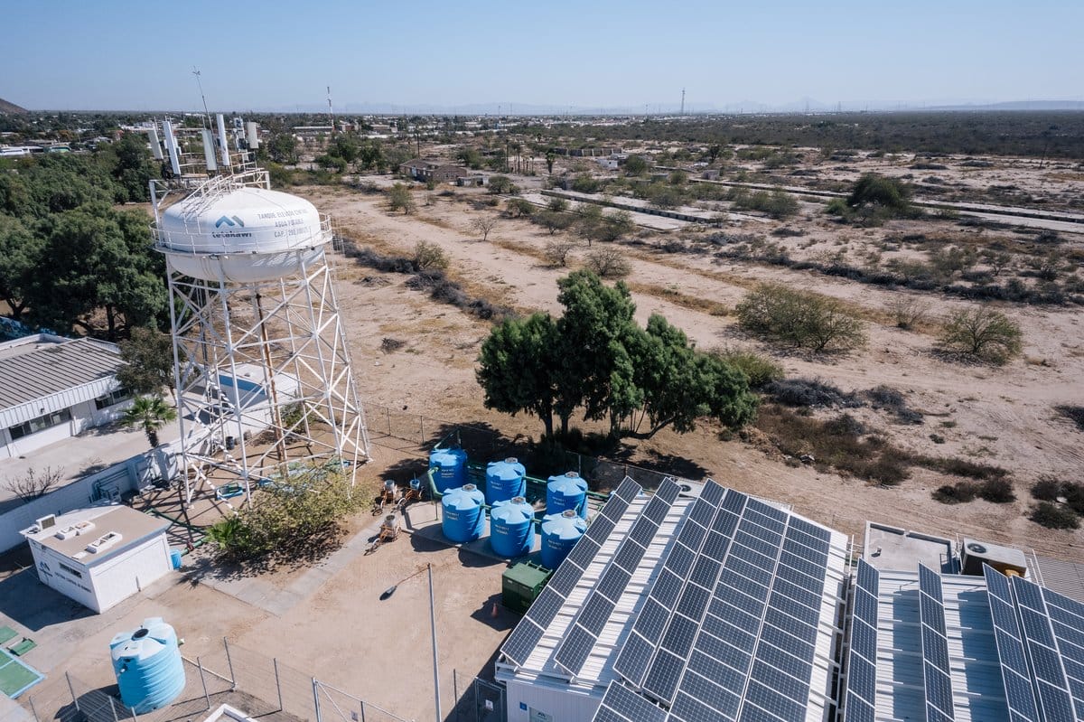Elevated water tower and rooftop solar panels showing utility infrastructure at a Manufacturing Campus in Mexico | Tetakawi