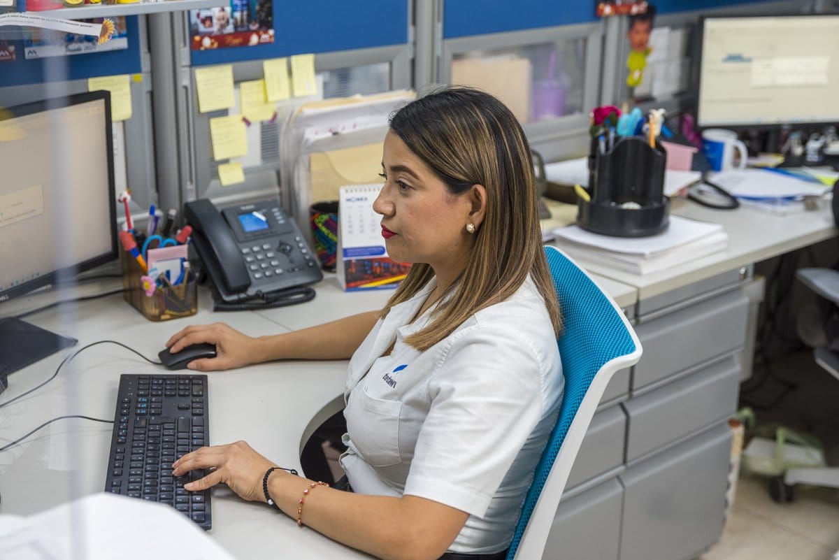 A Tetakawi employee reviews cost and administrative details at a Manufacturing Campus in Mexico | Tetakawi