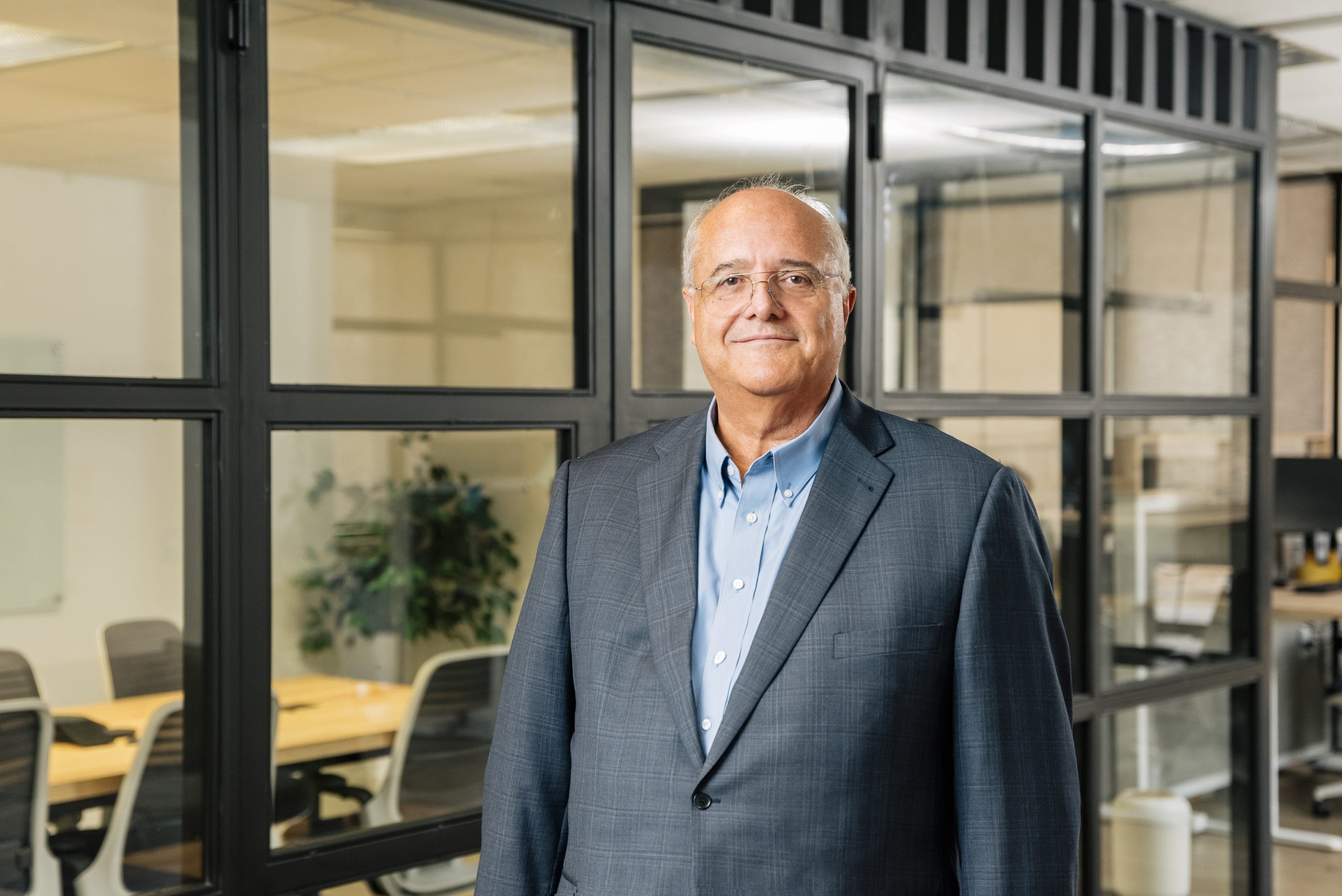 Eduardo Saavedra, EVP of Business Development at Tetakawi, standing in a glass-walled office | Tetakawi