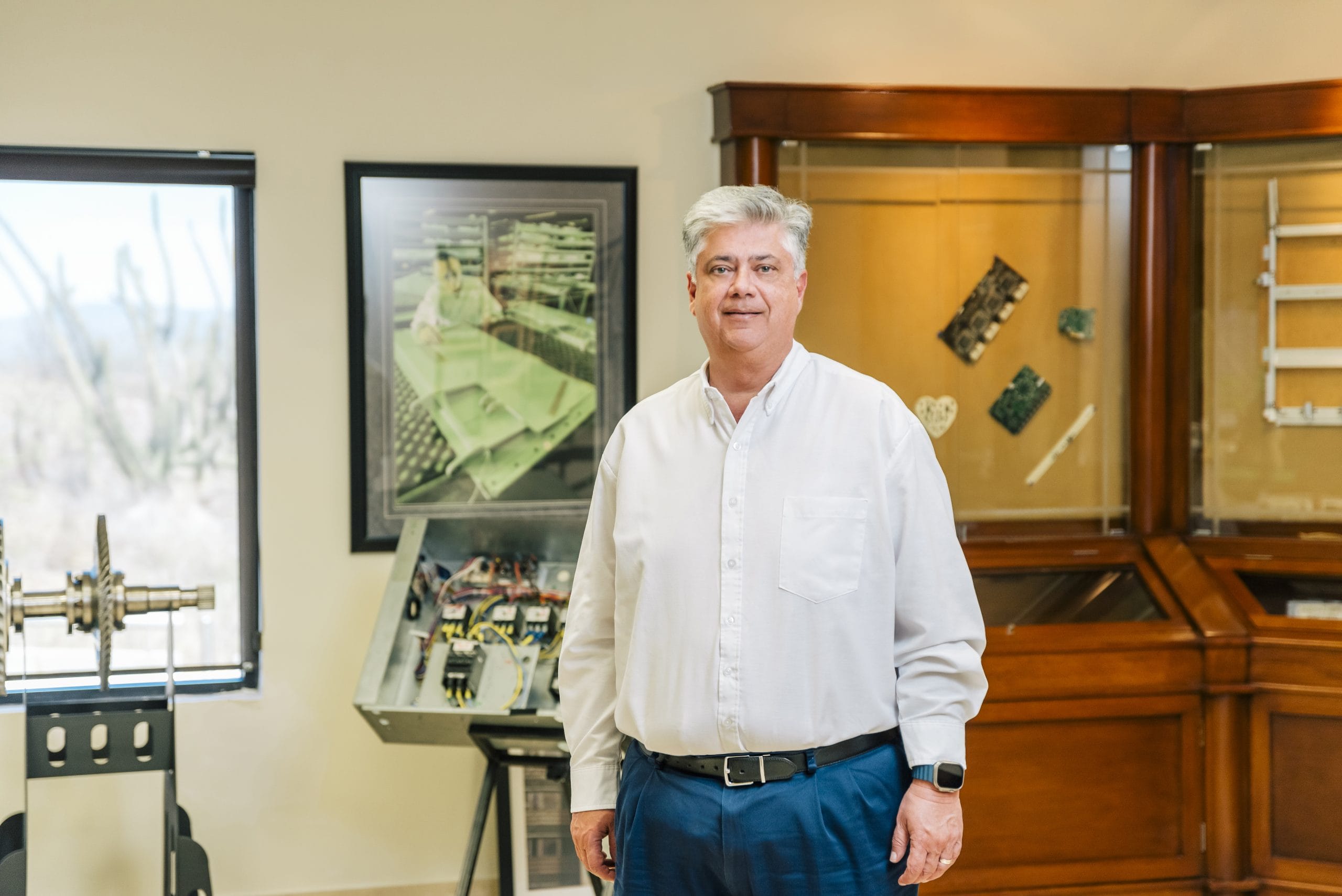 Jose Humberto Colunga, EVP of Technology and Innovation at Tetakawi, beside product display cases | Tetakawi