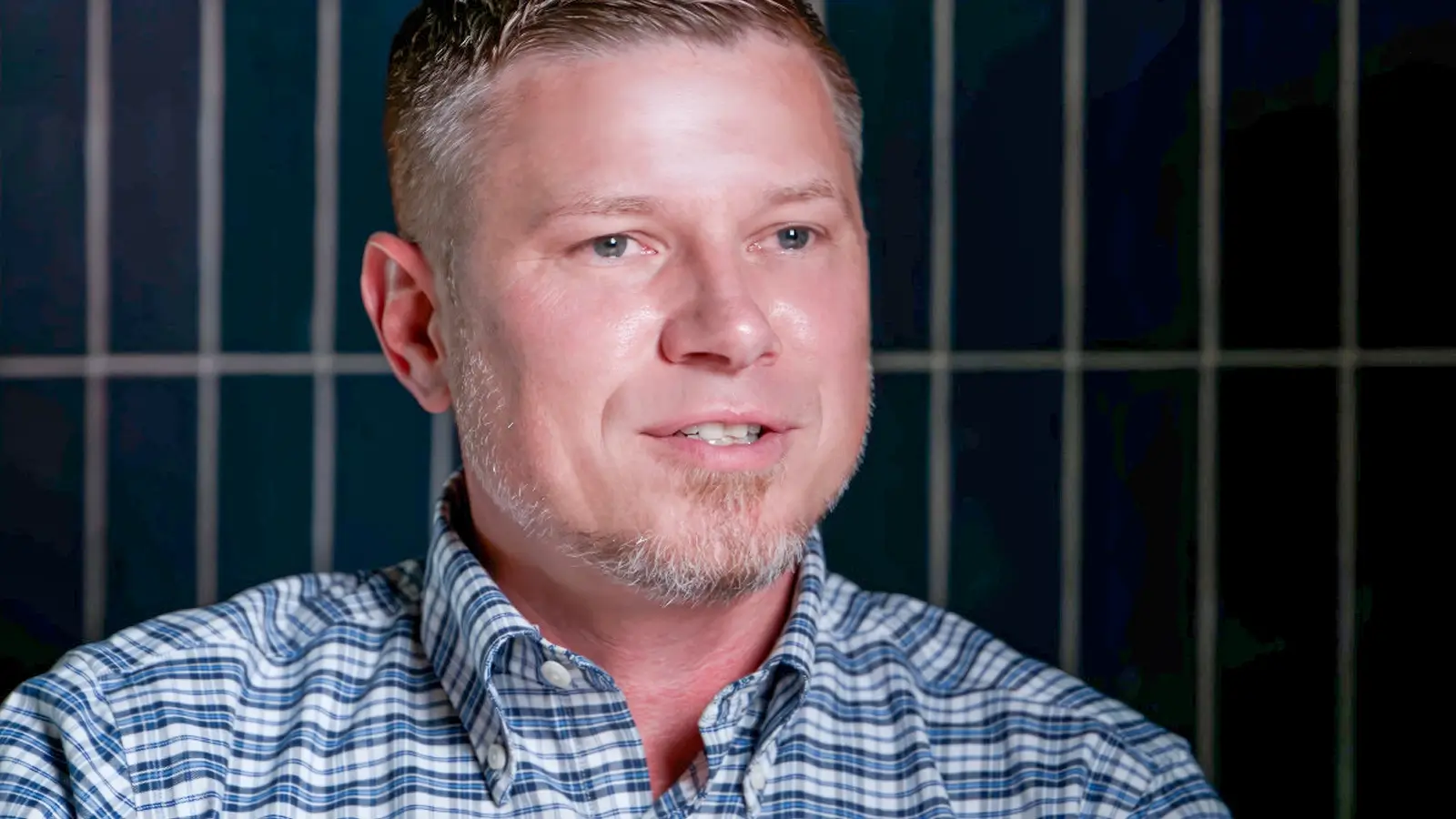 Man in a blue plaid shirt speaking in an interview for the CPP case study on aerospace manufacturing in Mazatlán | Tetakawi