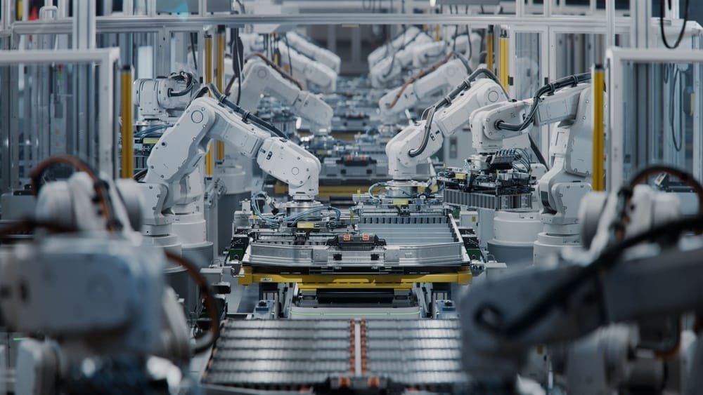 Robotic arms assembling an EV battery pack on an automotive manufacturing line | Tetakawi