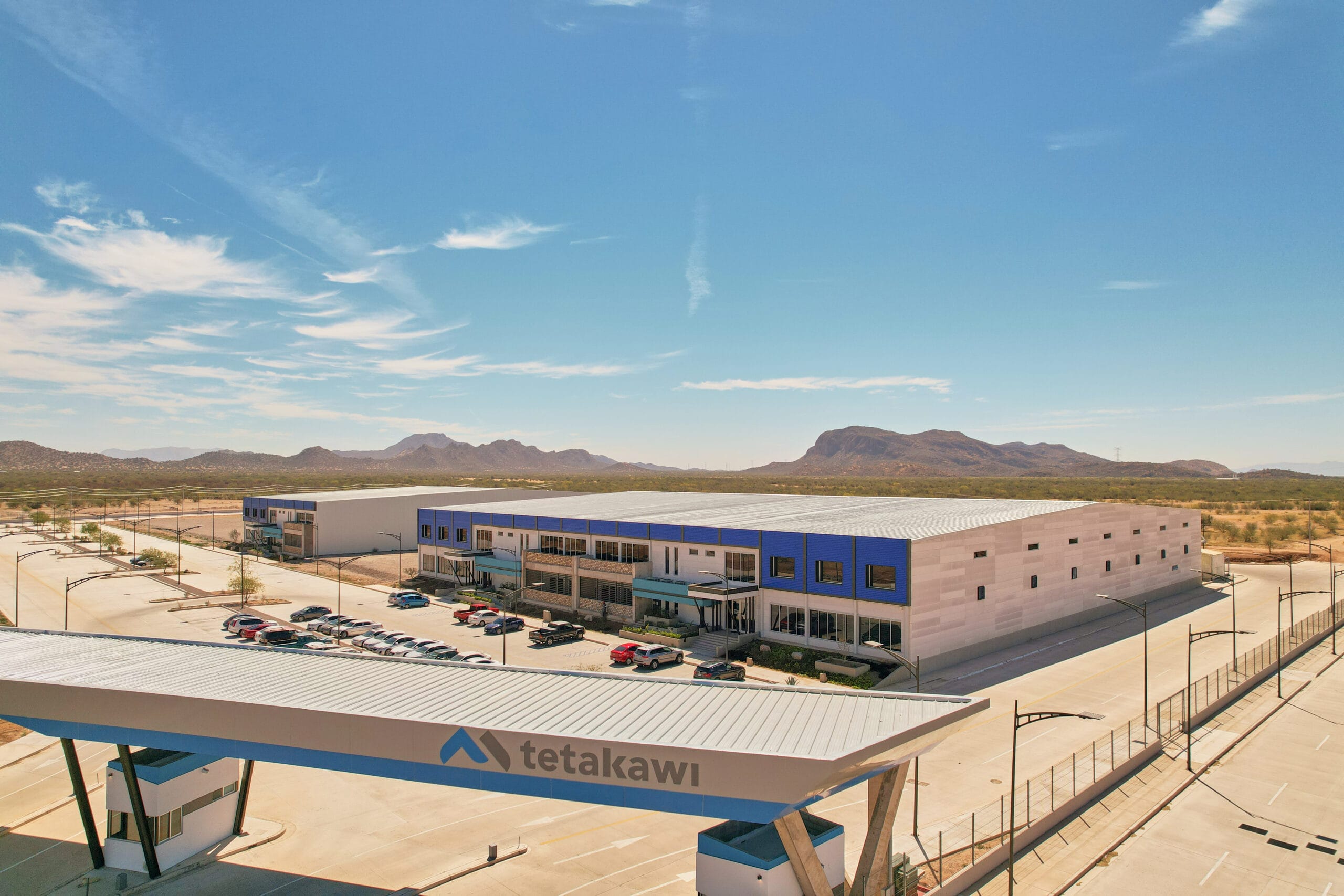 Aerial view of the gated entrance and manufacturing building at Tetakawi's Río Sonora Campus in Hermosillo, Sonora, Mexico | Tetakawi