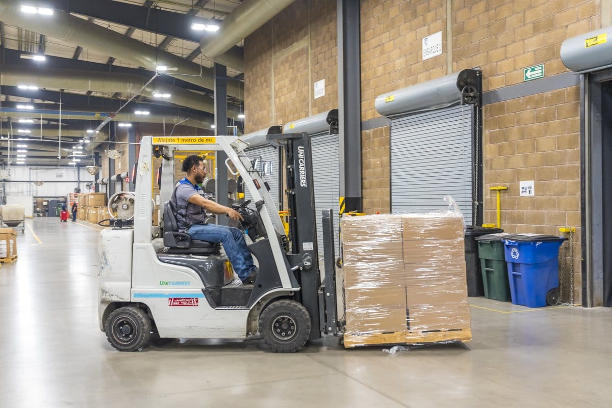 A forklift moving a wrapped export shipment at a Tetakawi Manufacturing Campus, an ideal Mexico export base | Tetakawi