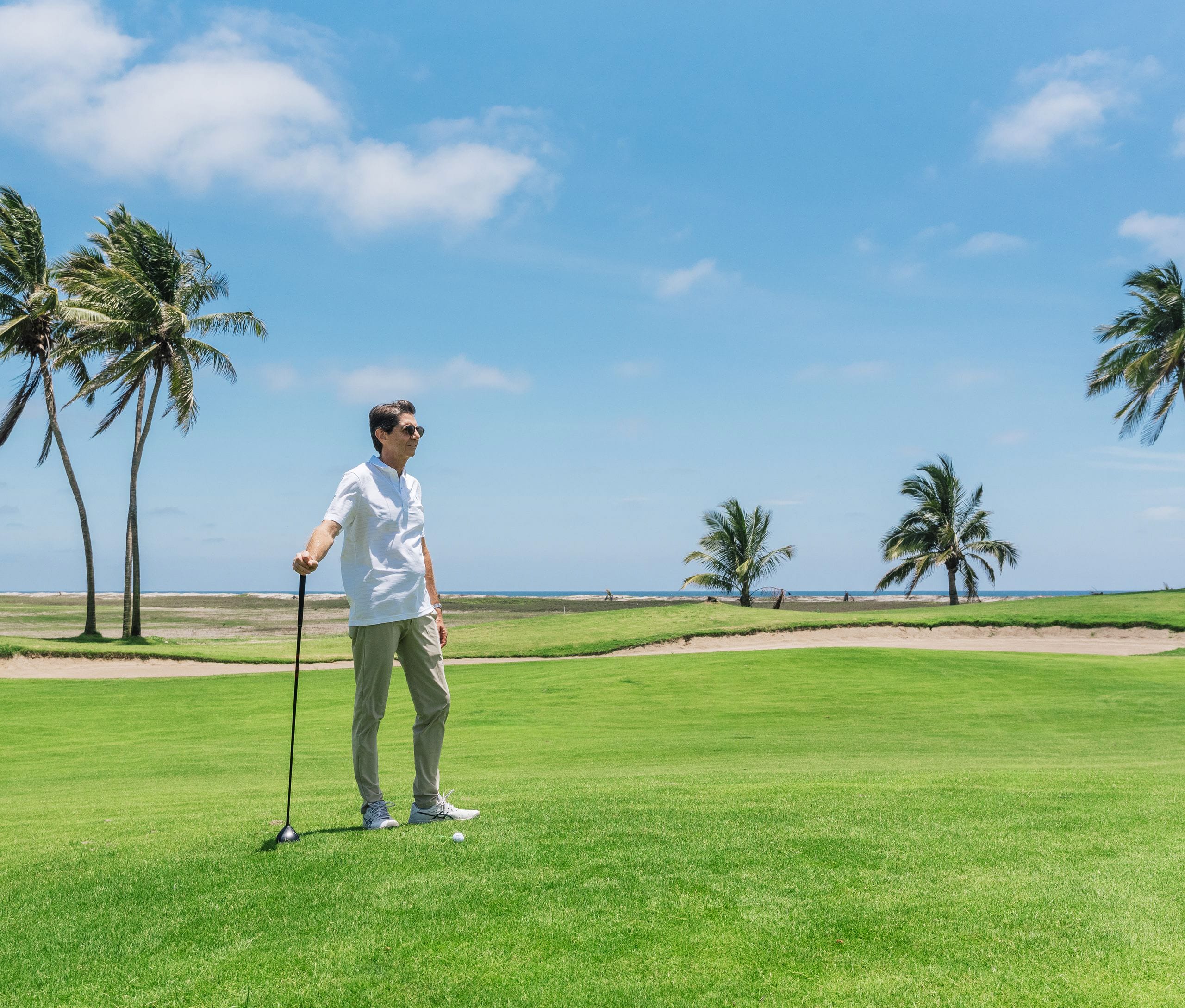 Golfer enjoying an oceanfront course near the Mazatlán Manufacturing Campus