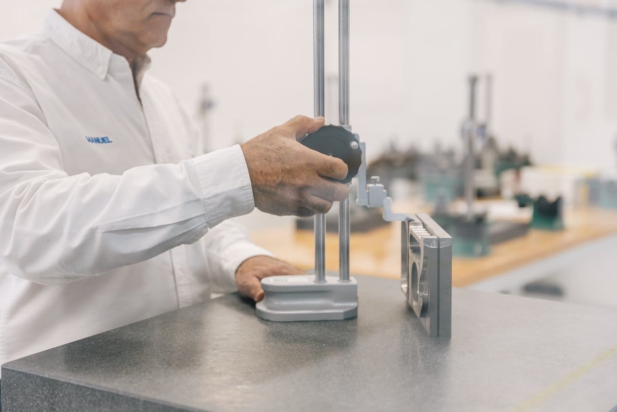 A skilled Tetakawi technician measuring a precision part, reflecting the average wage manufacturers pay in Mexico | Tetakawi