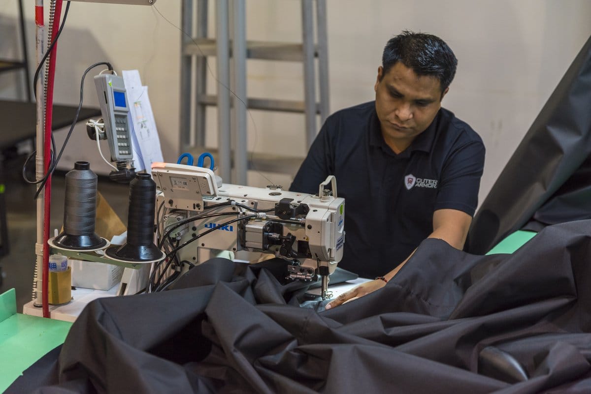 Sewing machine operator assembling a garment in textile and apparel manufacturing in Mexico | Tetakawi