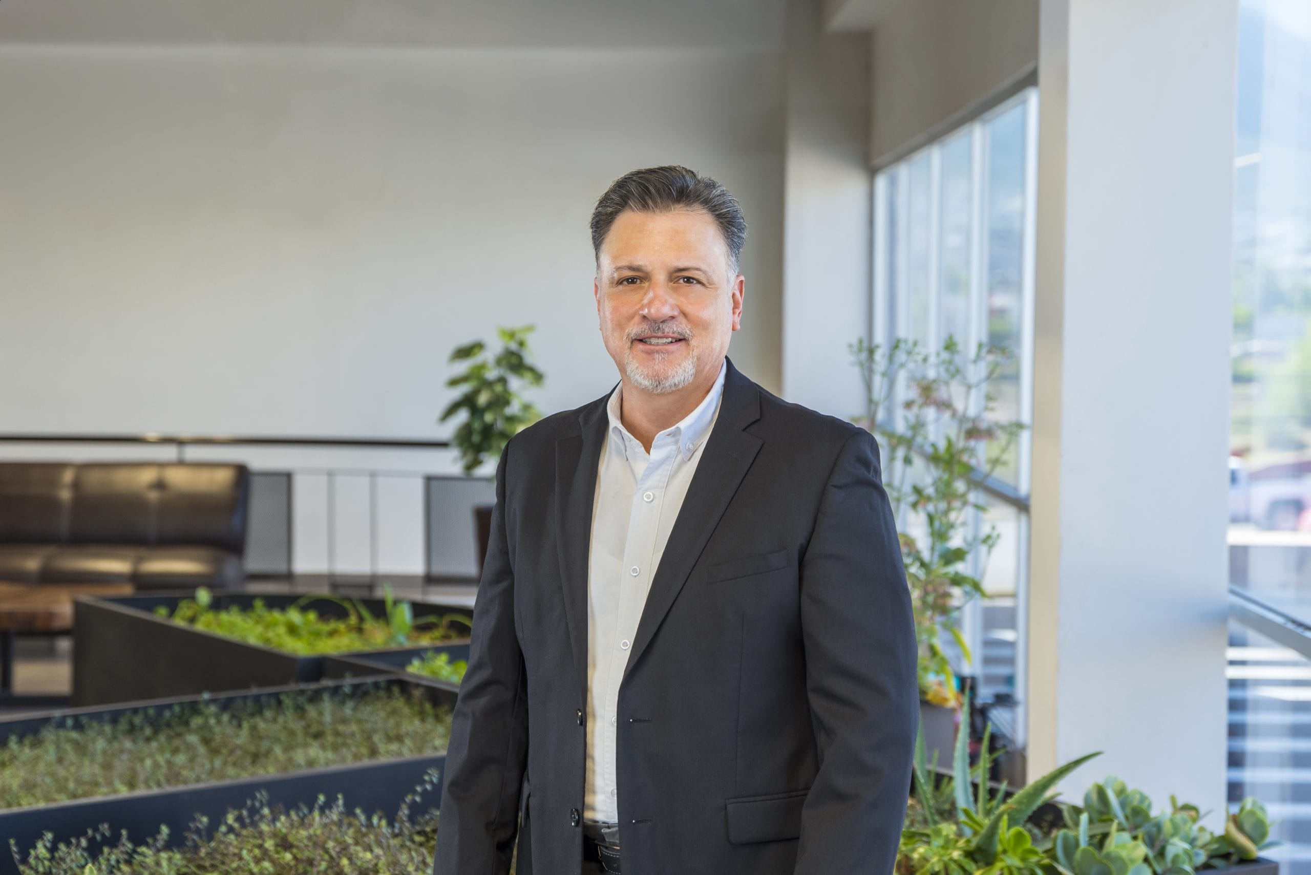 Tetakawi team member in a dark suit at the Zapa Manufacturing Campus offices in Saltillo, Mexico | Tetakawi