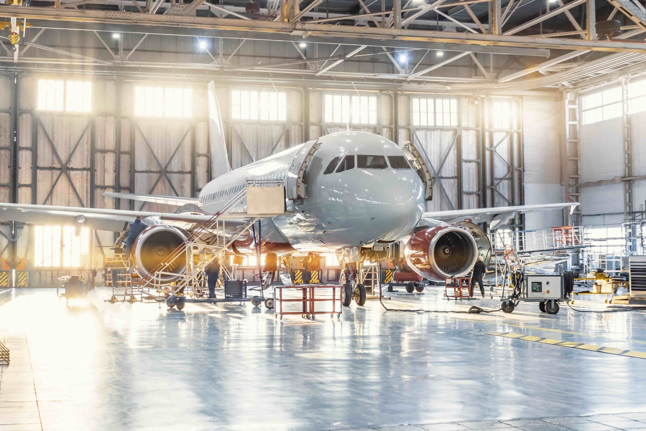 Commercial jet with its engine cowling open in a maintenance hangar, aerospace manufacturing in Mexico | Tetakawi