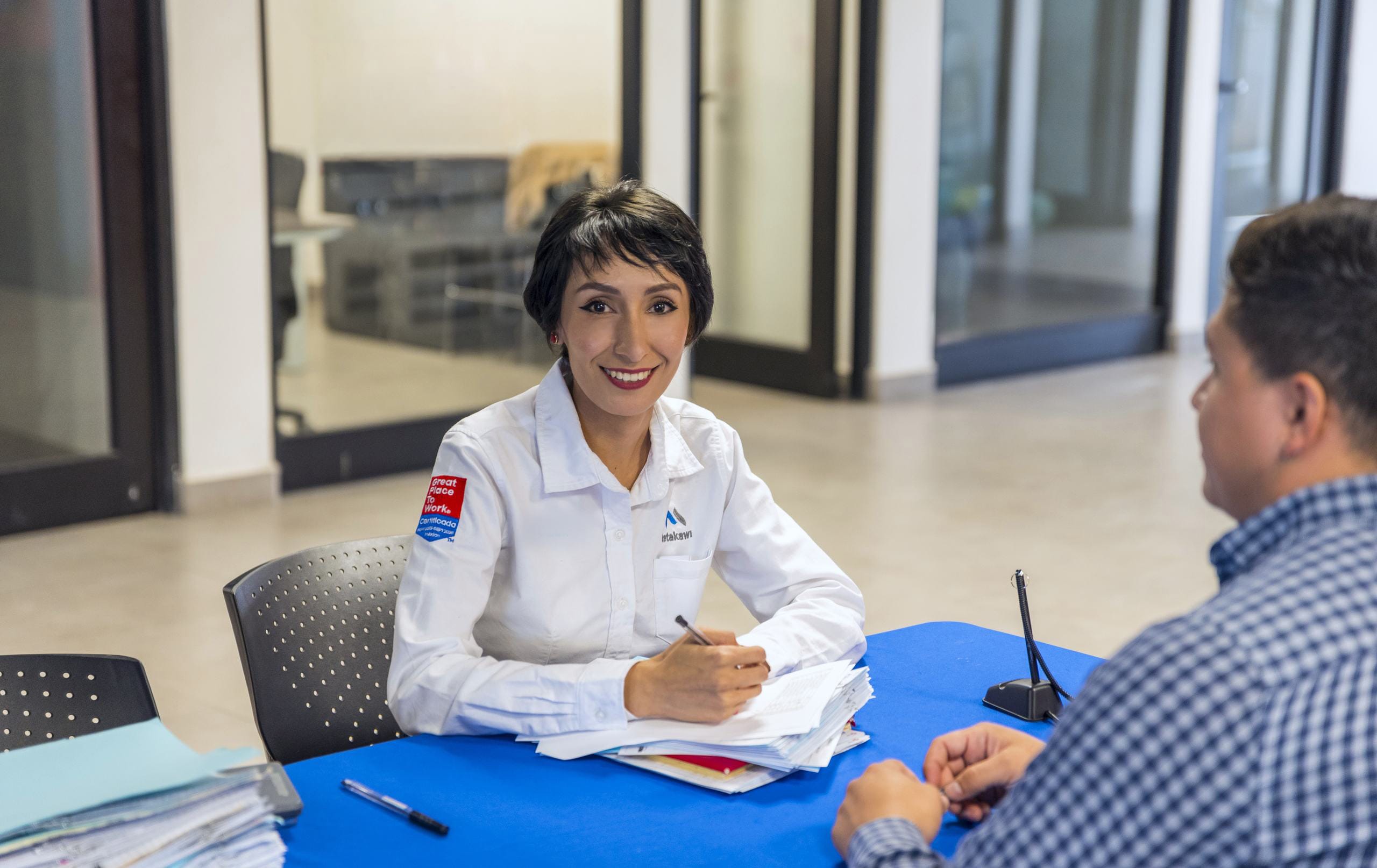 HR team member reviewing payroll and personnel documents with a plant manager at a Tetakawi Campus in Mexico | Tetakawi