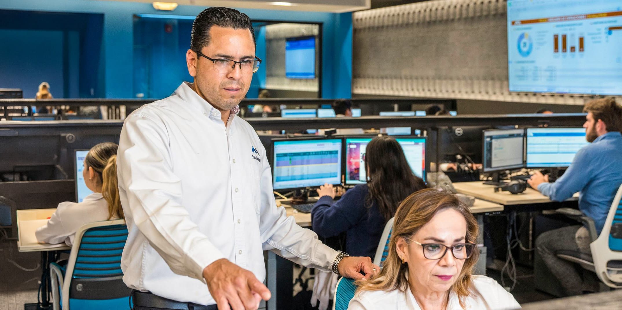Tetakawi team members reviewing production data in a manufacturing control room in Mexico