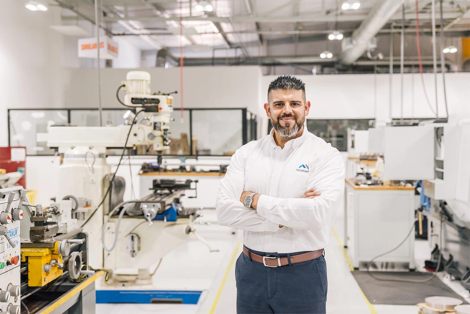 Tetakawi team member in a machine shop with milling machines and lathes at the Roca Fuerte Campus in Guaymas | Tetakawi