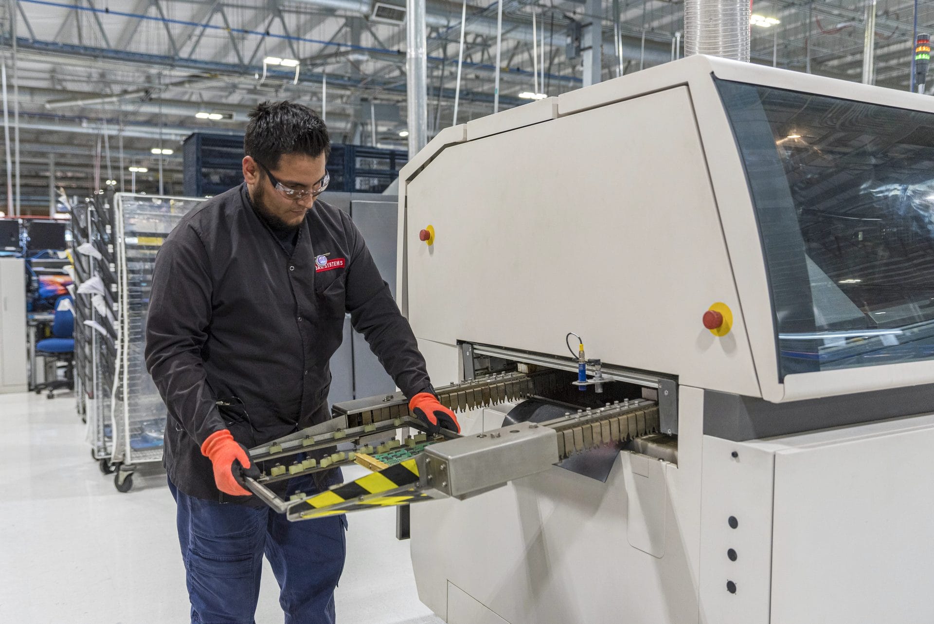 BAE Systems technician operating aerospace assembly equipment at Tetakawi's Roca Fuerte Campus in Guaymas | Tetakawi Keywords: bae systems, roca fuerte campus, guaymas, tetakawi, aerospace manufacturing mexico