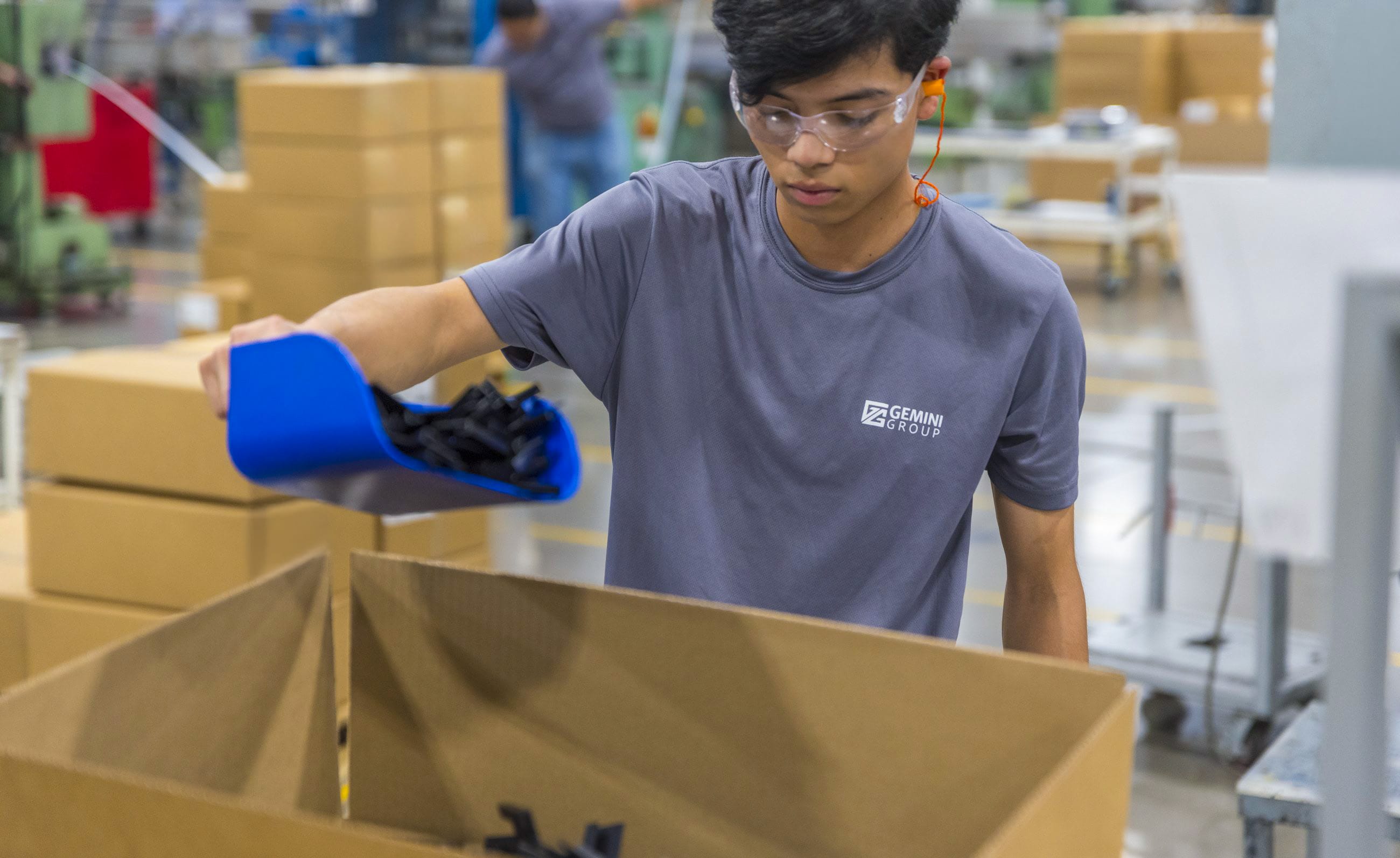 Gemini Group employee sorting automotive components at a Tetakawi Manufacturing Campus