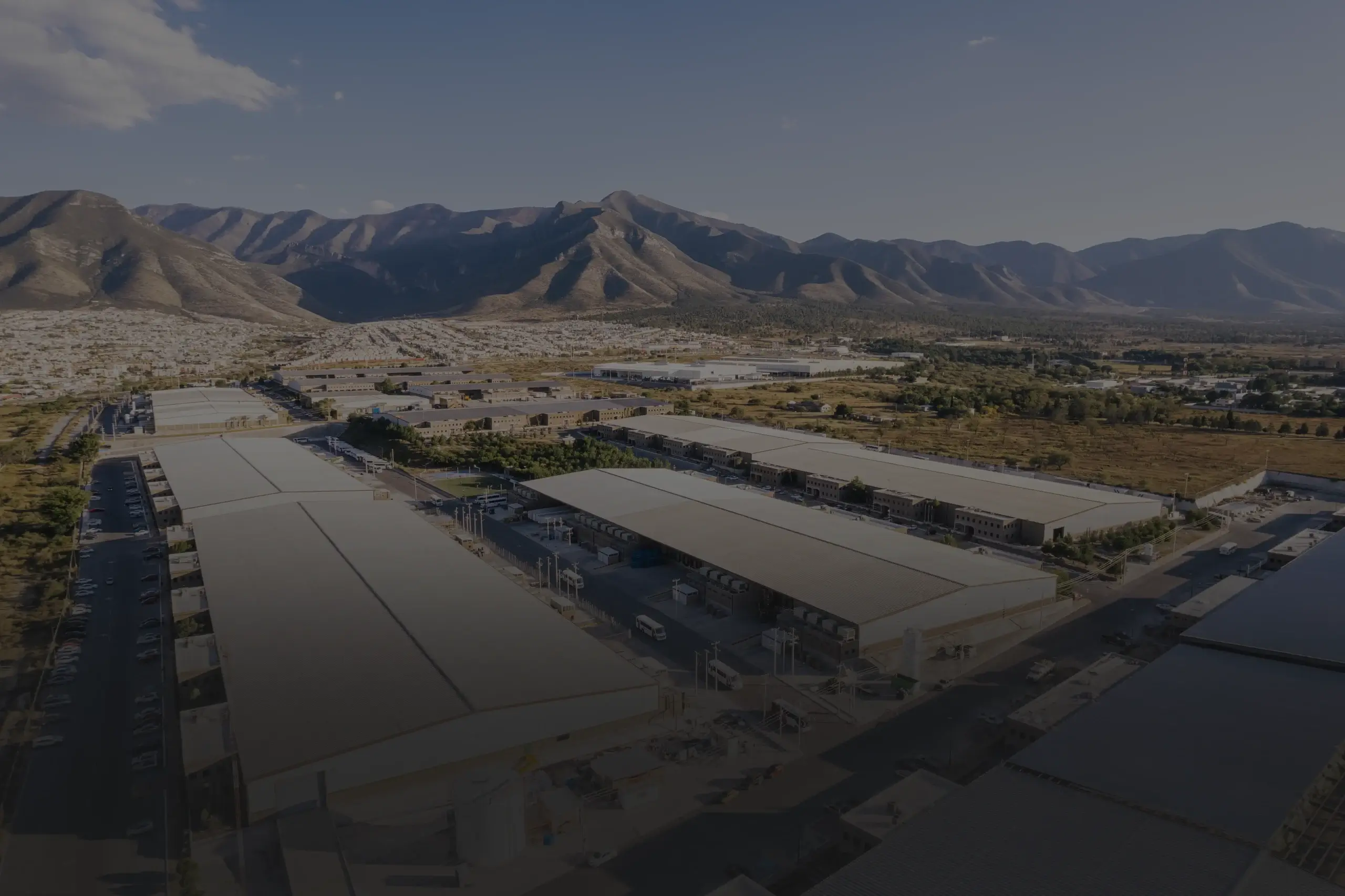 Aerial view of Tetakawi's Zapa Manufacturing Campus in Mexico set against the Sierra mountains | Tetakawi