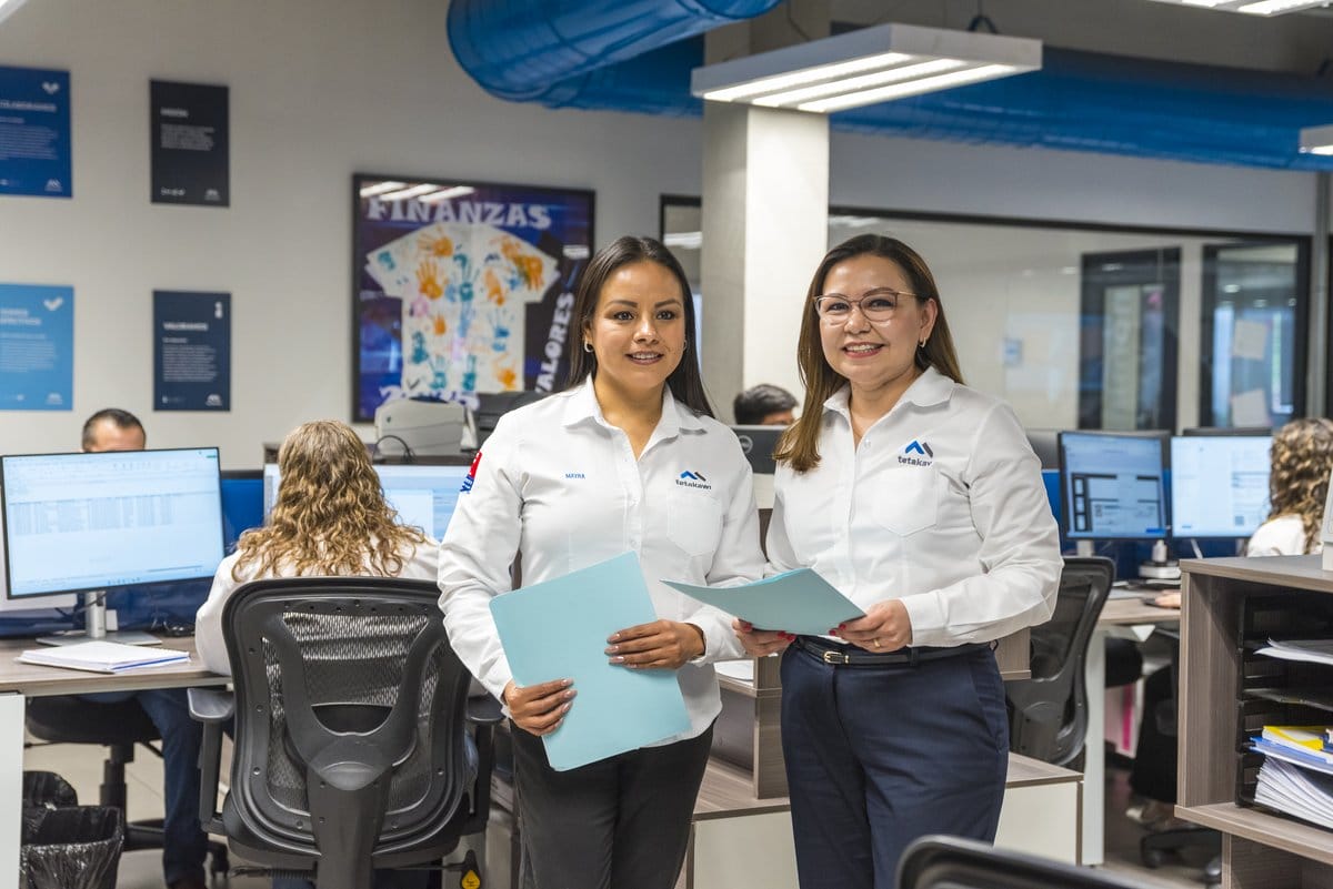 Tetakawi finance team members with documents at a Manufacturing Campus office in Saltillo, Mexico | Tetakawi