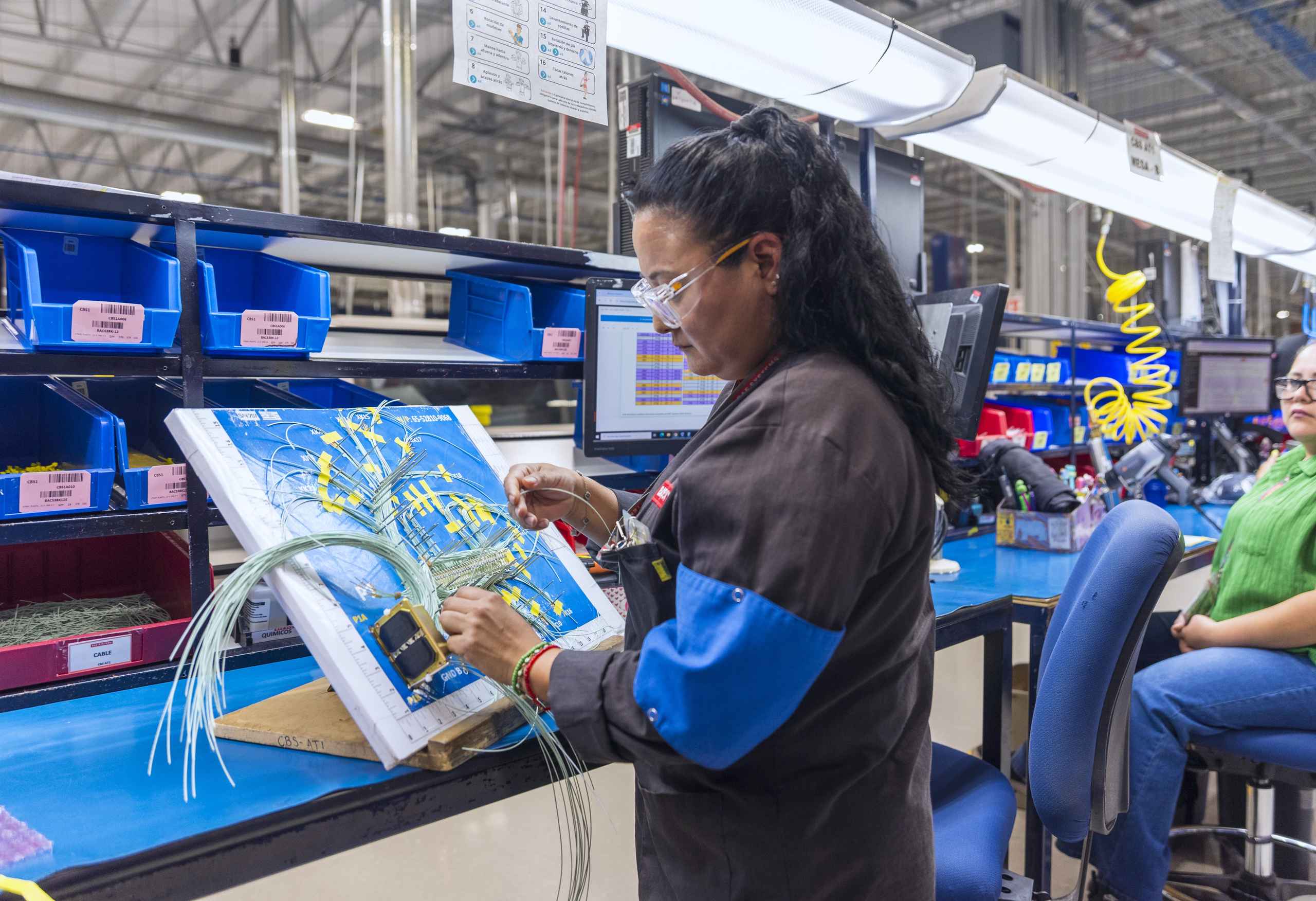 Operator assembling a wire harness at Tetakawi's BAE Systems manufacturing operation in Guaymas, Mexico | Tetakawi