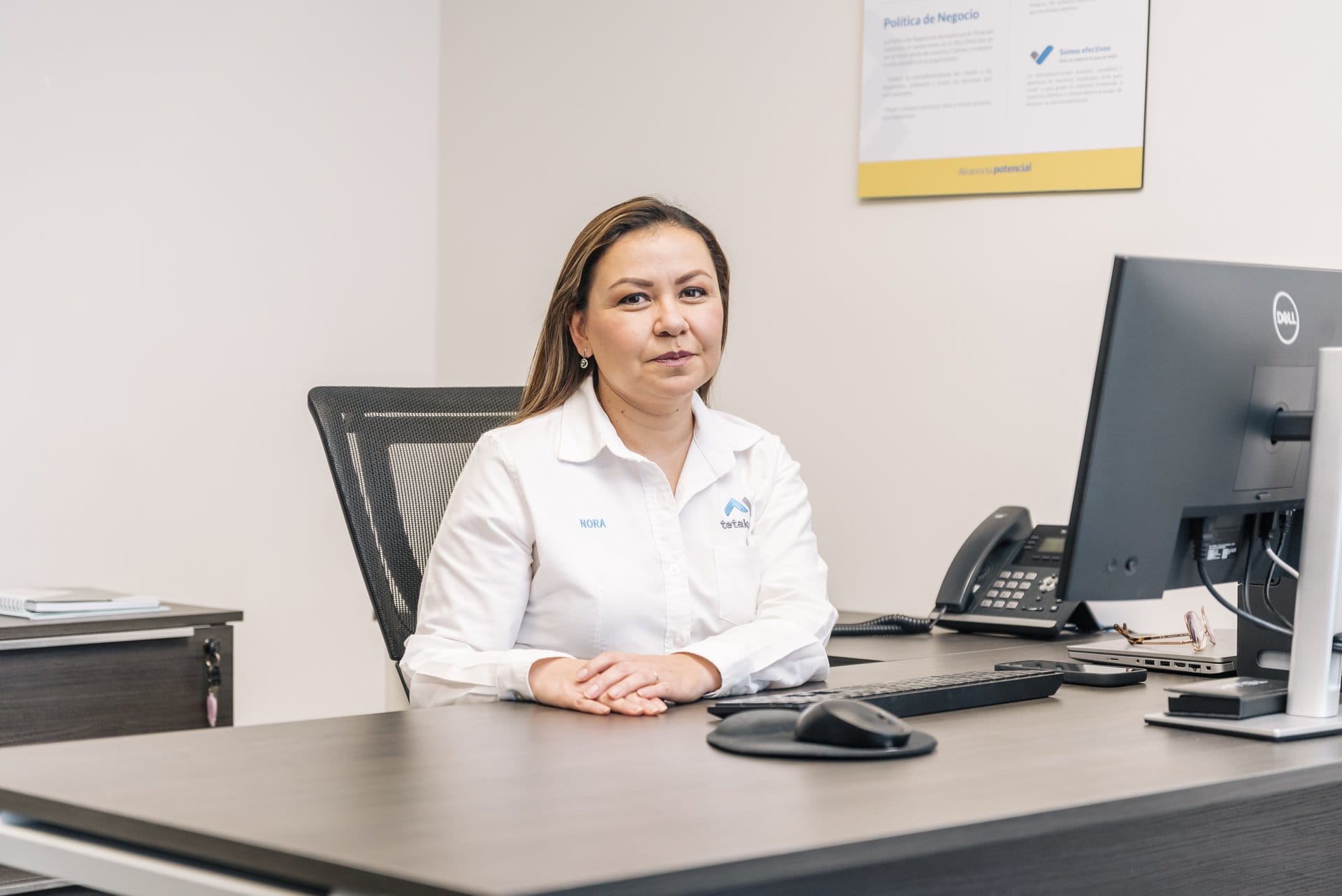 A Tetakawi office administrator at her desk, supporting the documentation and compliance behind Mexico's IMMEX program | Tetakawi