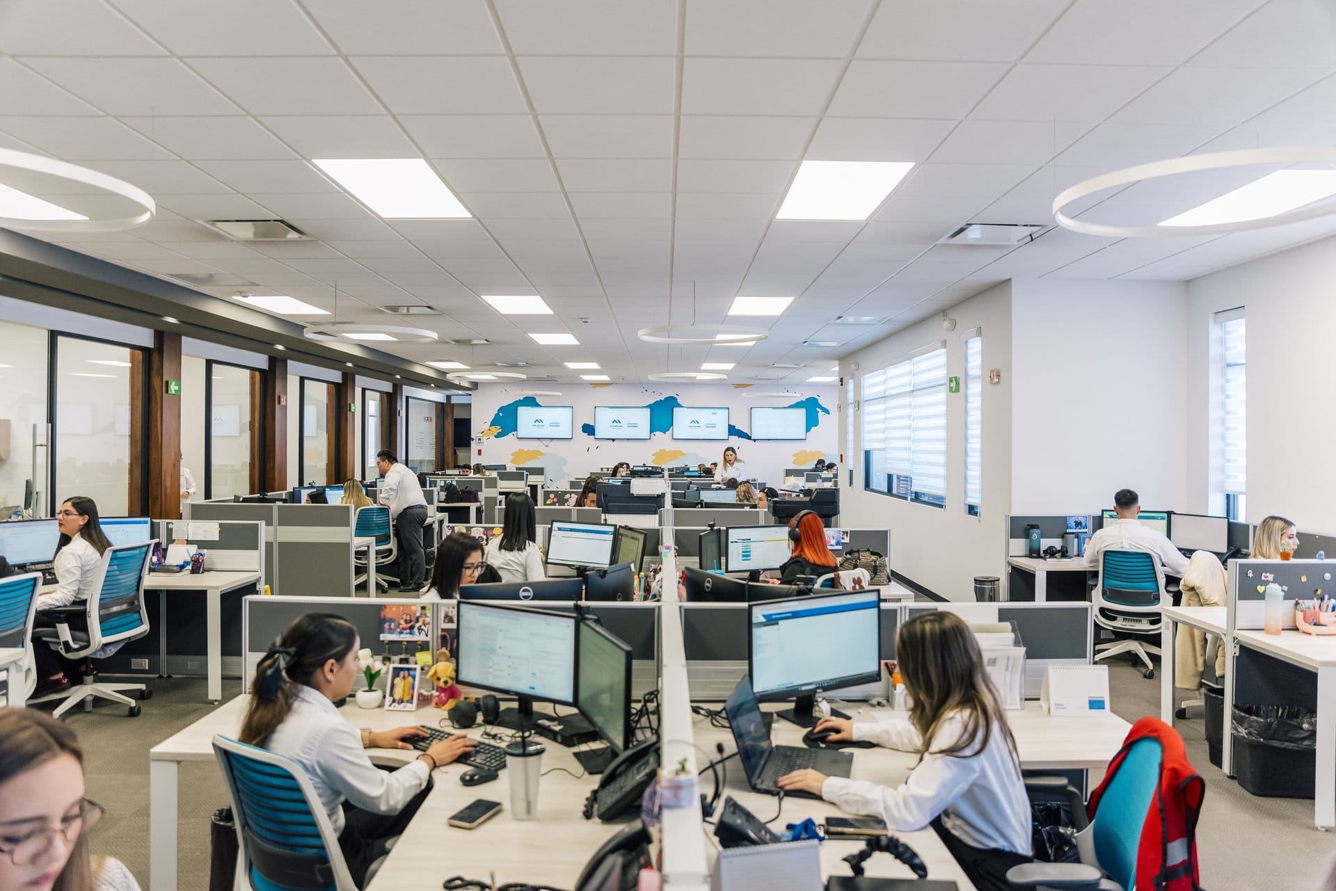 Employees work at their desks in the back-office of a Tetakawi Manufacturing Campus in Mexico | Tetakawi