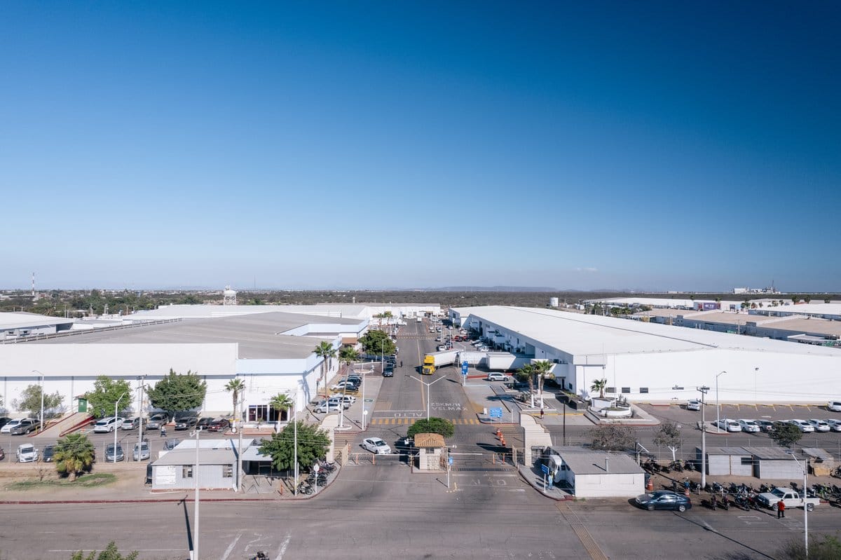 Aerial view of a Tetakawi Manufacturing Campus in Empalme, Sonora, with its internal access road and gate | Tetakawi