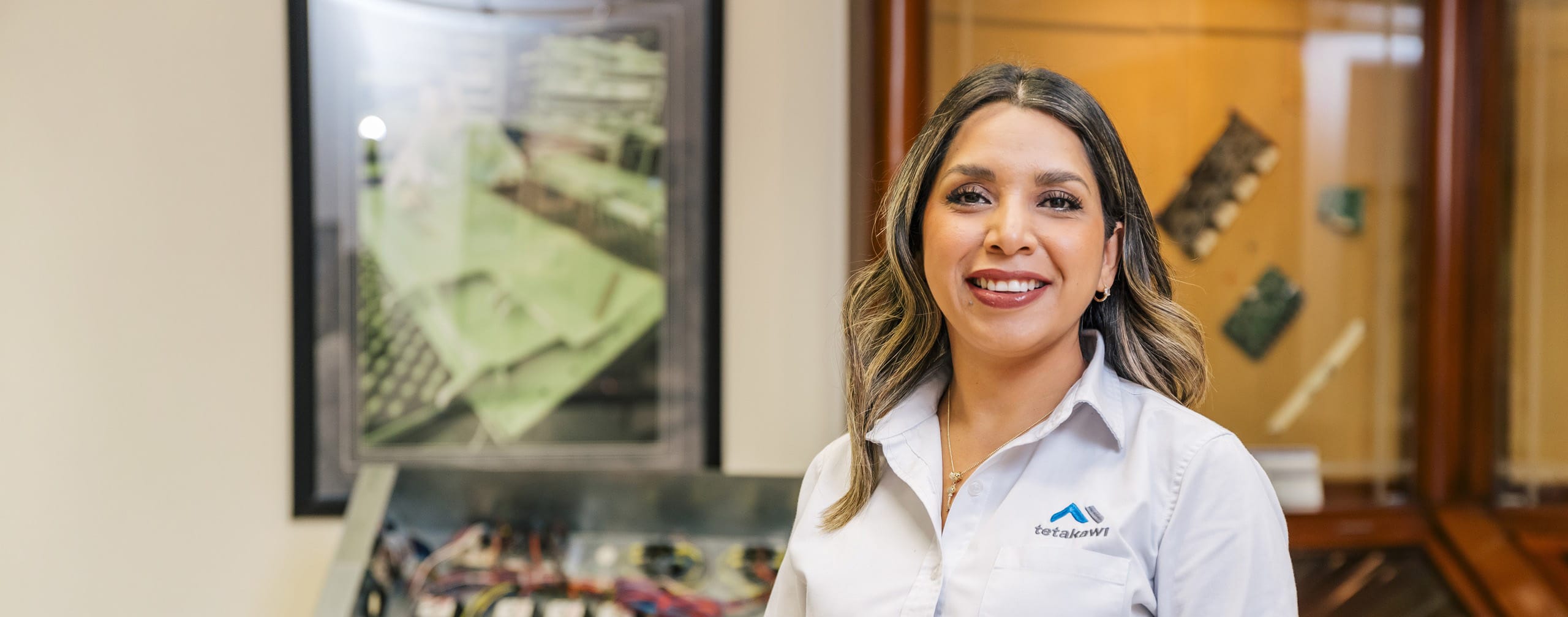 Tetakawi team member in an office with manufacturing project displays, representing the complete solution for manufacturing in Mexico