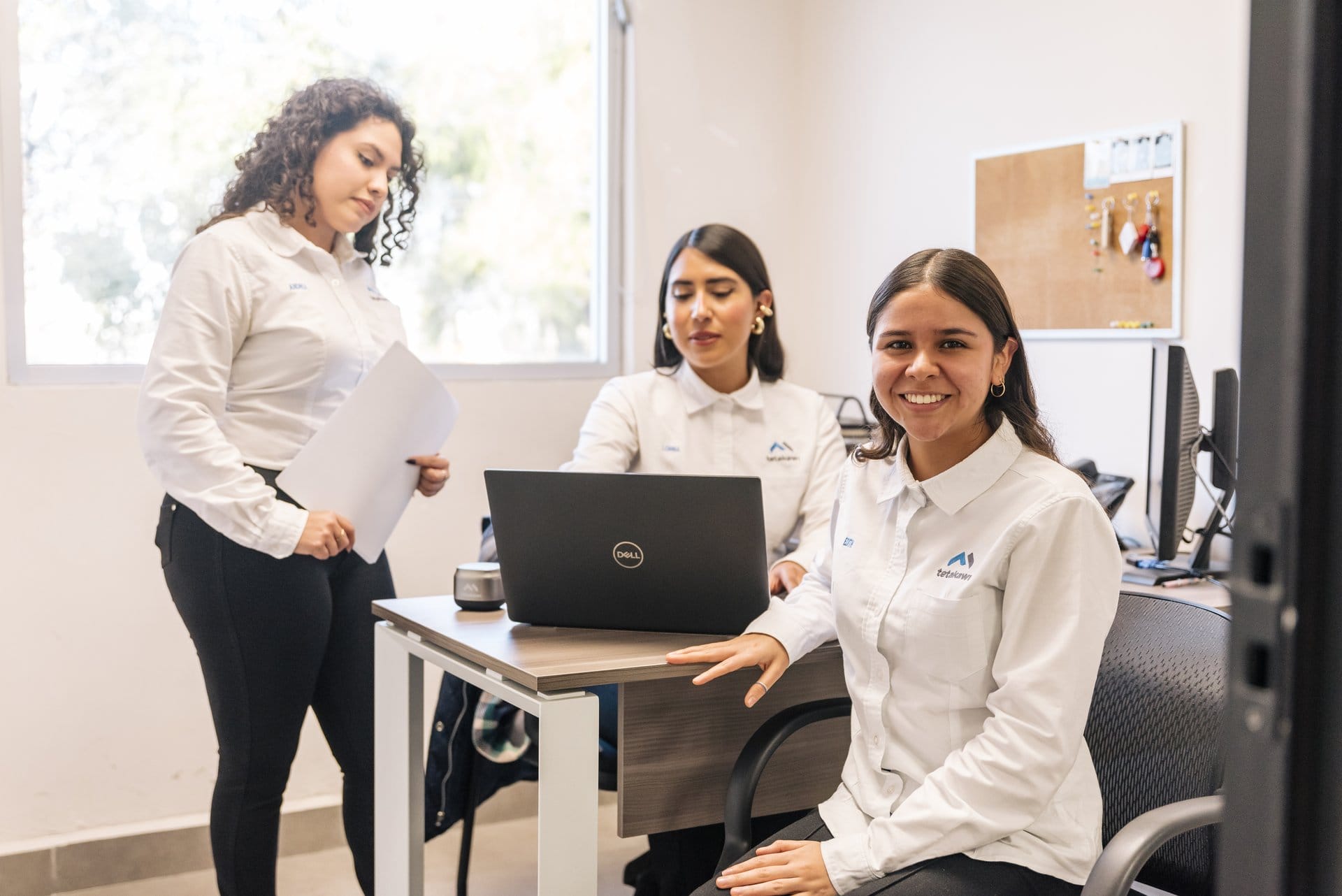 Tetakawi shelter services staff review documentation together in a back-office setting in Mexico | Tetakawi