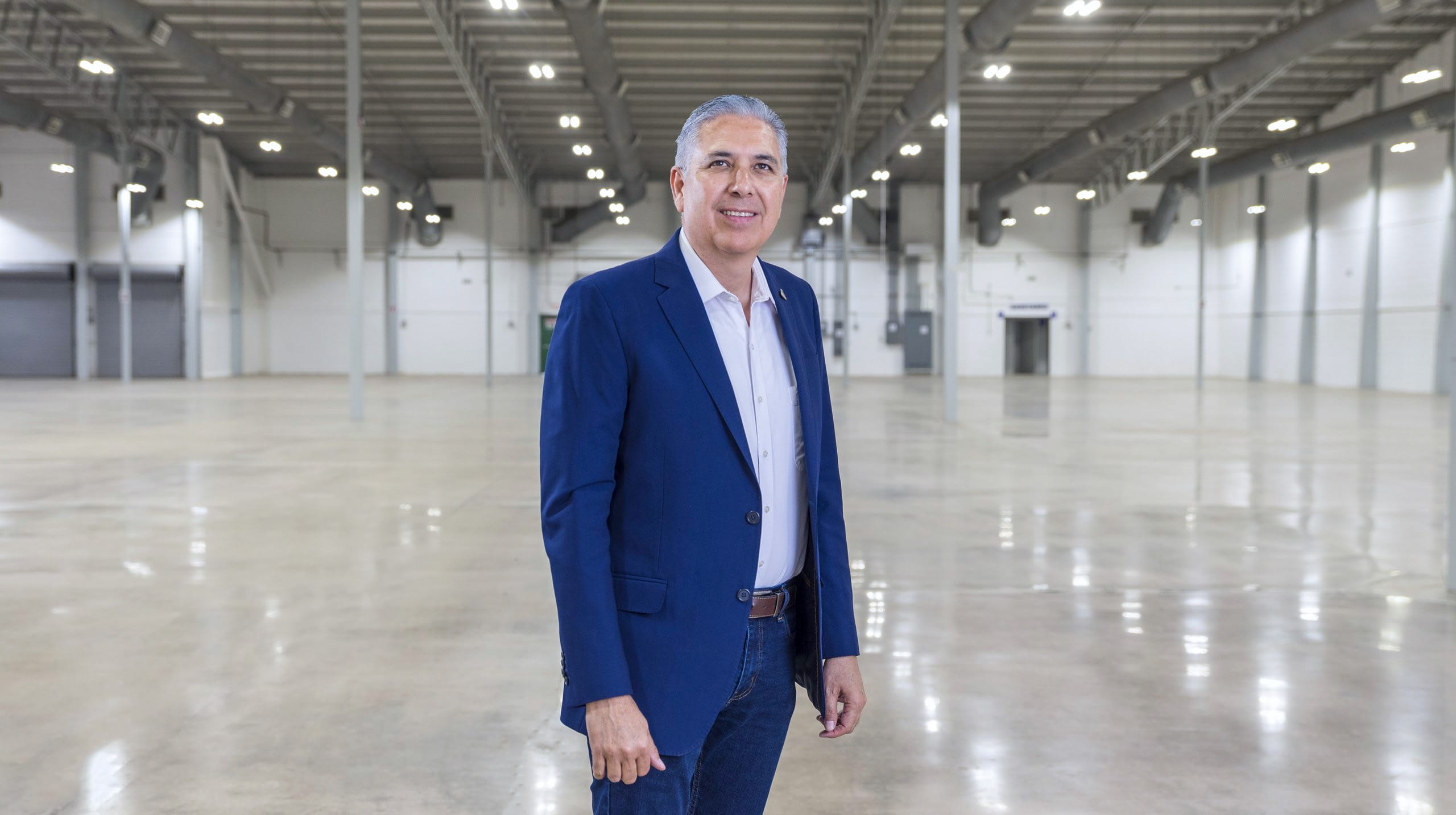 Tetakawi leader walking through a manufacturing building being prepared for a new operation to launch in Mexico